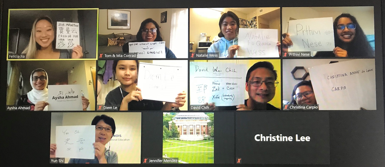 Screenshot of a virtual meeting with several people holding up a piece of paper