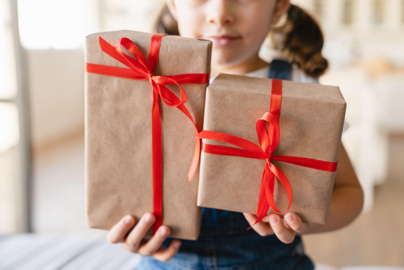 girl holding focused birthday presents