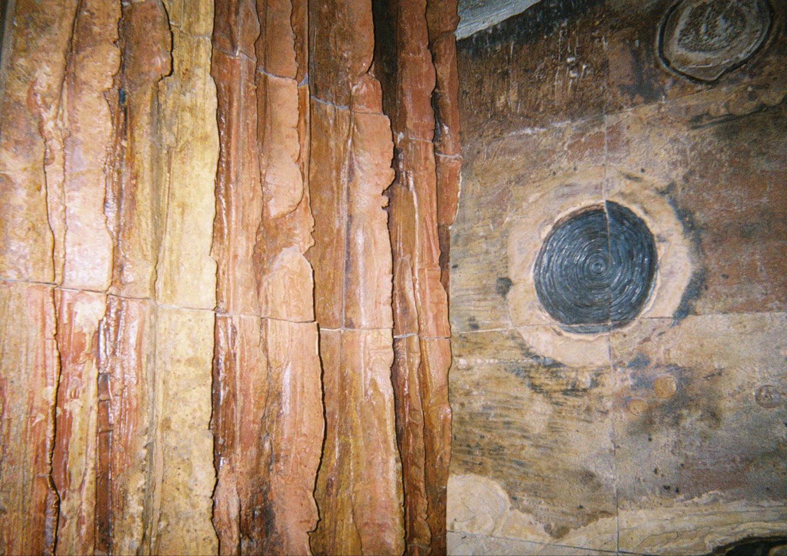 Image: Detail shot of Earth, Water, Sky, 1968. Earth-tone linear grooves on the left and a spiraled circle on the right. Courtesy of the author.