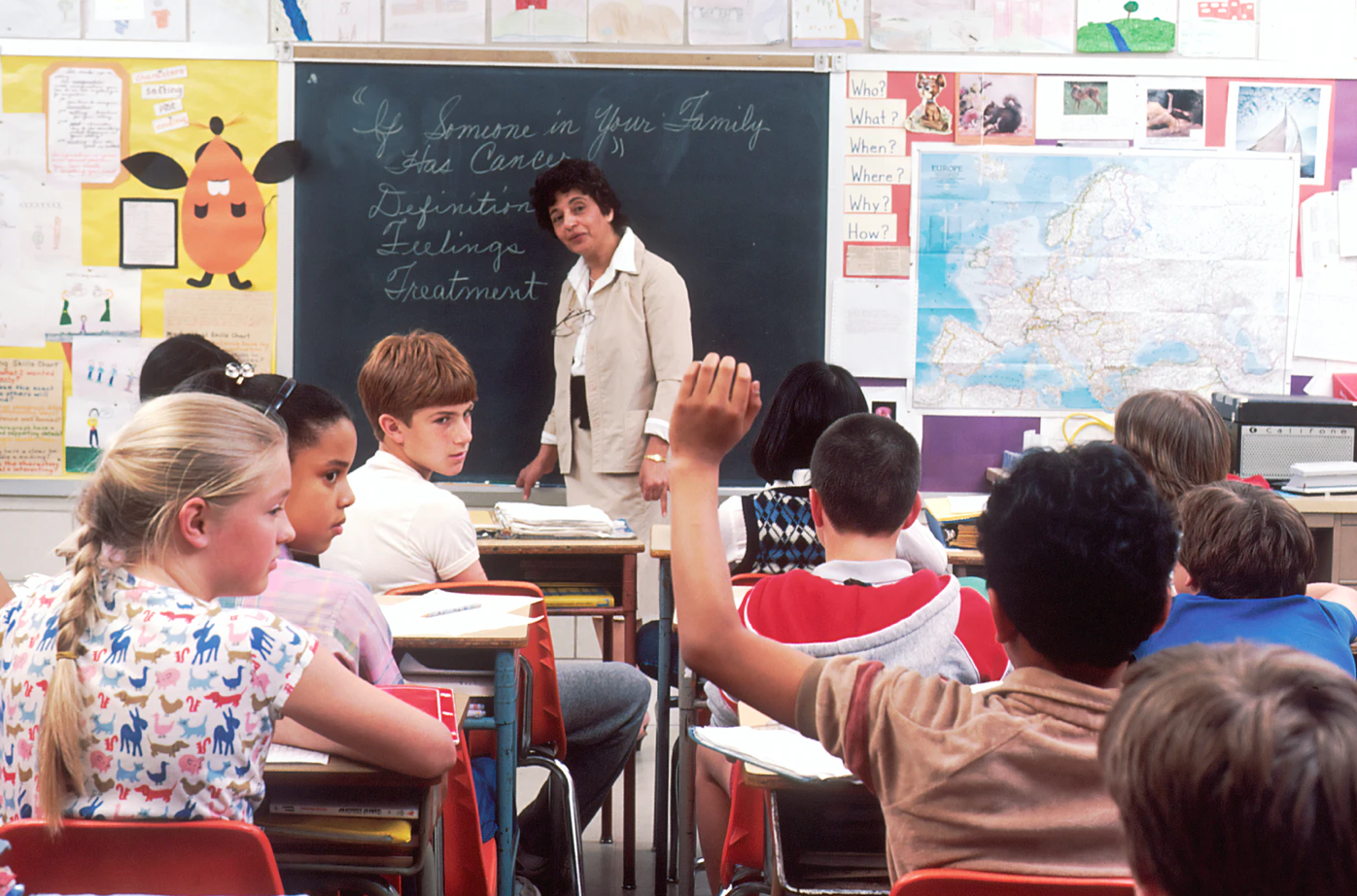 students learning in a hybrid classroom with a teacher