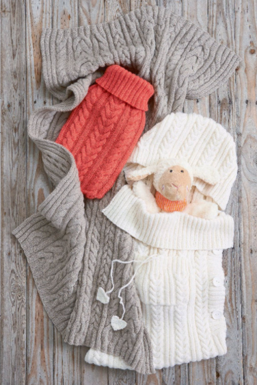 cabled baby sleep sack lying on wooden surface