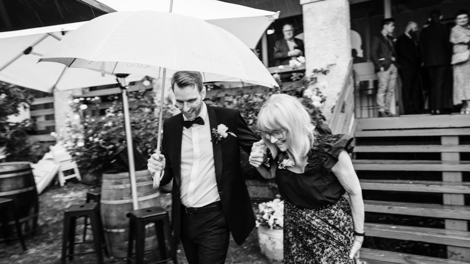 Groom walking his mum to his ceremony captured with a narrative-style wedding photography