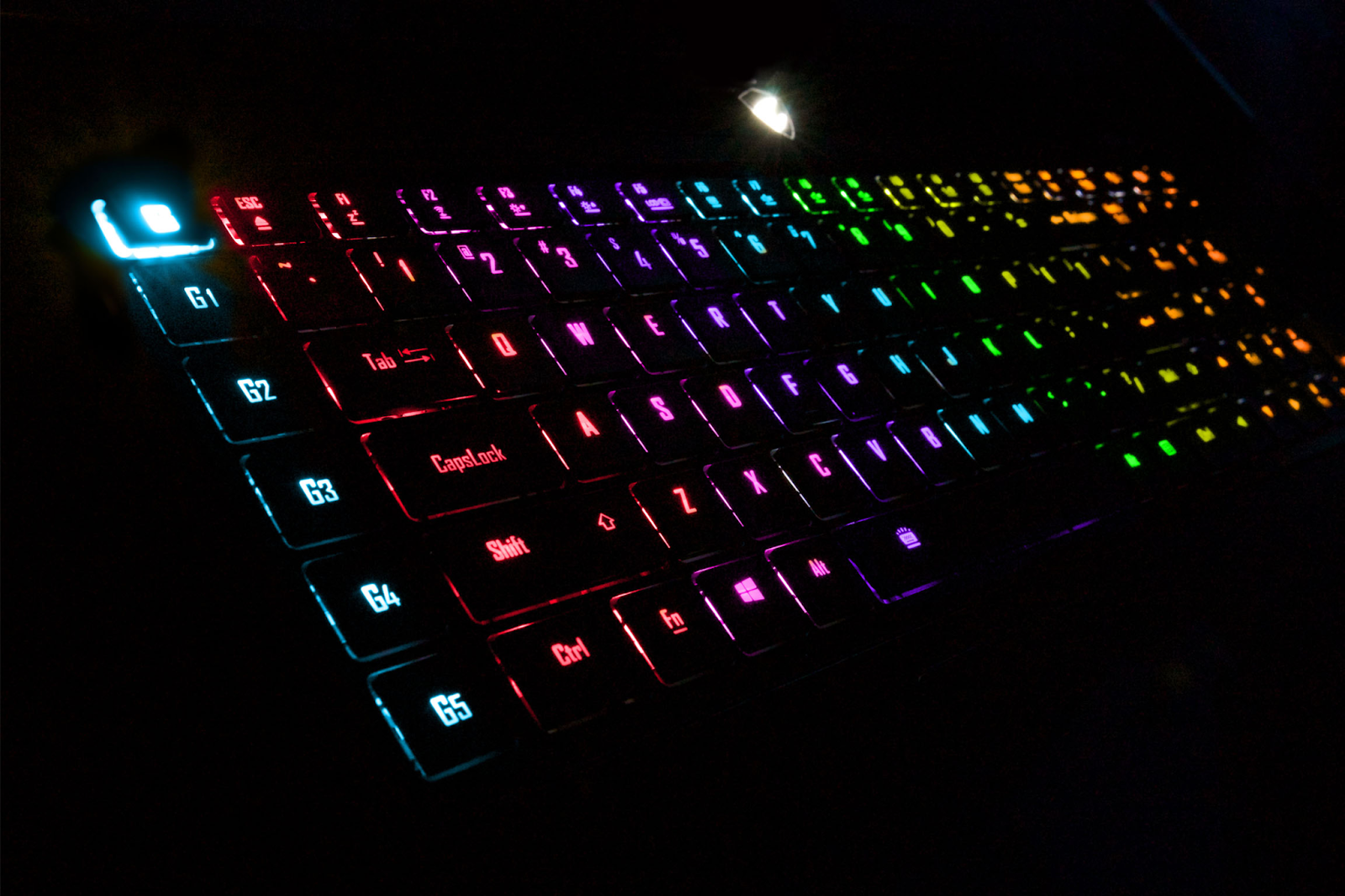 A laptop with a gaming keyboard that has RGB lighting allows for gaming and use in low-light conditions. 