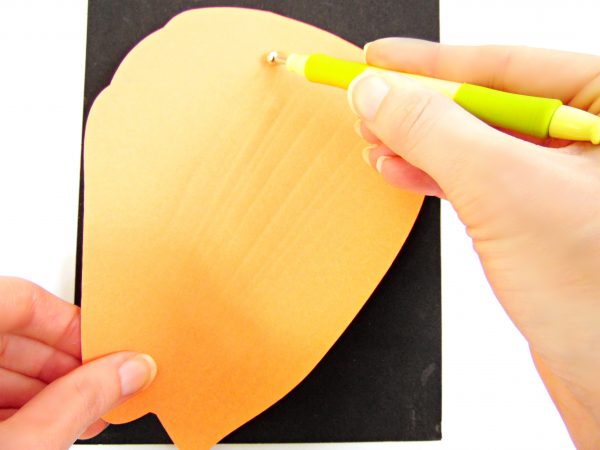 Abbi creates veins on this giant orange hibiscus petal by drawing lines with an embossing tool. 