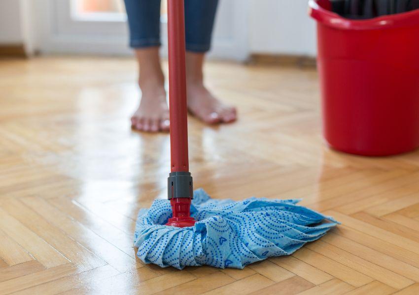 person-cleaning-floor-with-mop
