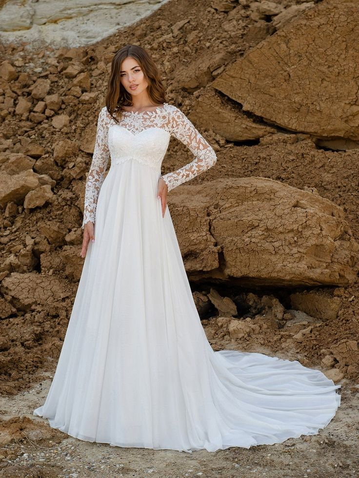 A bride with a flat tummy wearing a long-sleeved A-line wedding dress