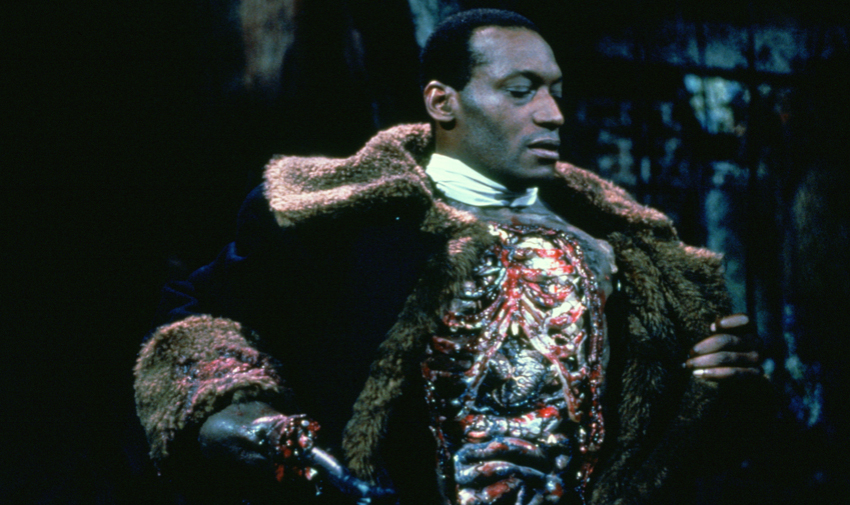 Photo of Tony Todd depicting The Candyman. In these scene, The Candyman has opened his jacket to show his exposed rib cage.