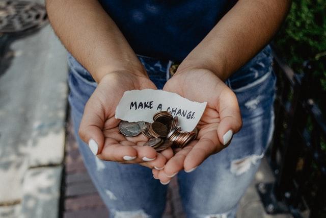 Person holding change in her hands.