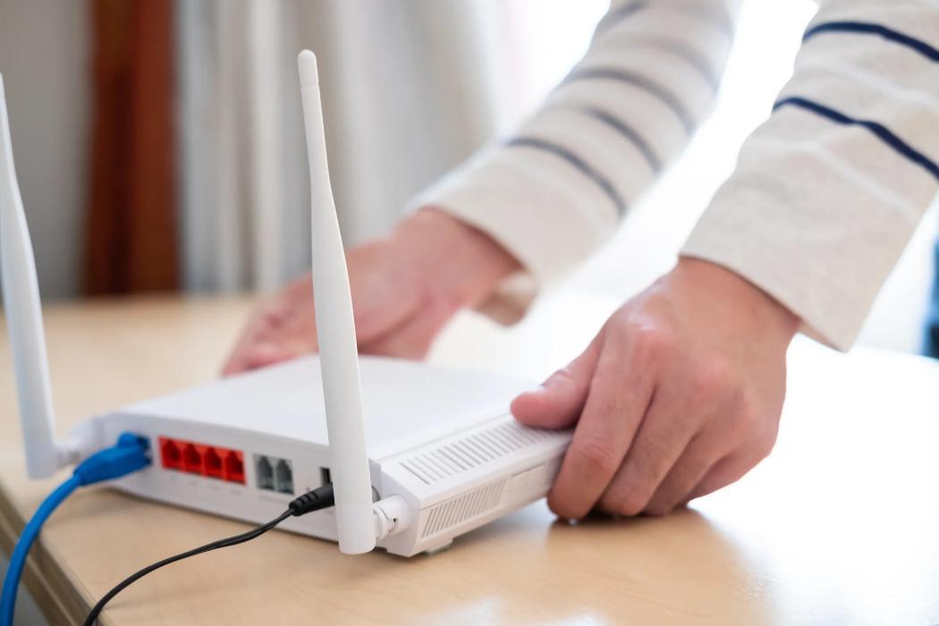 A person placing their modem on a table