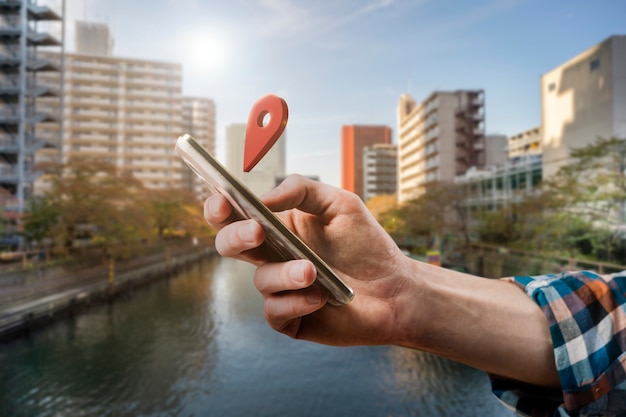 Free photo side view hand holding smartphone