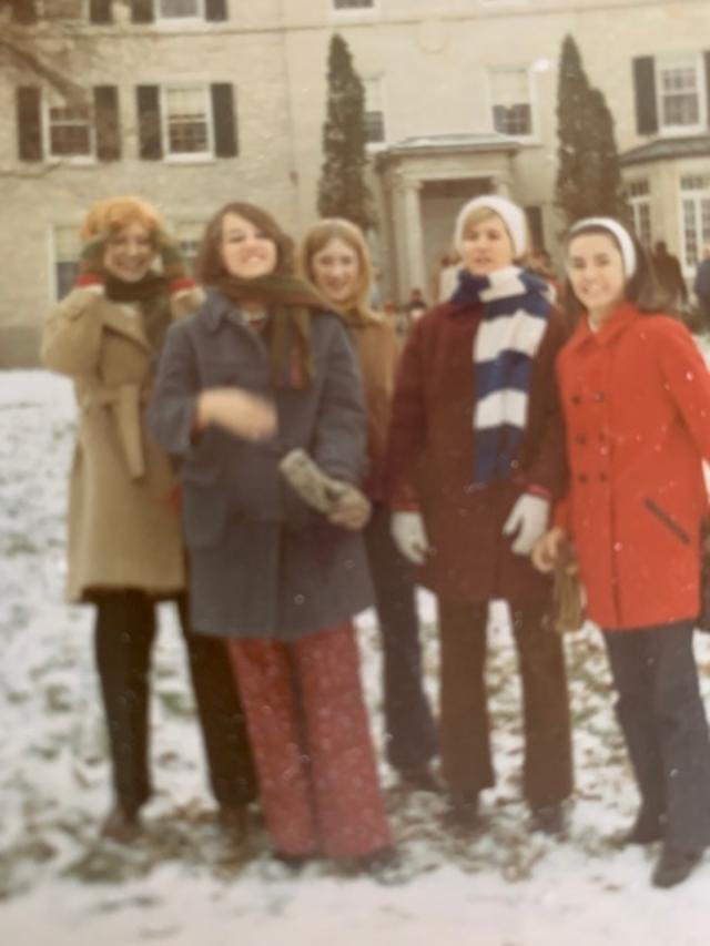 A group of people standing in the snowDescription automatically generated with medium confidence