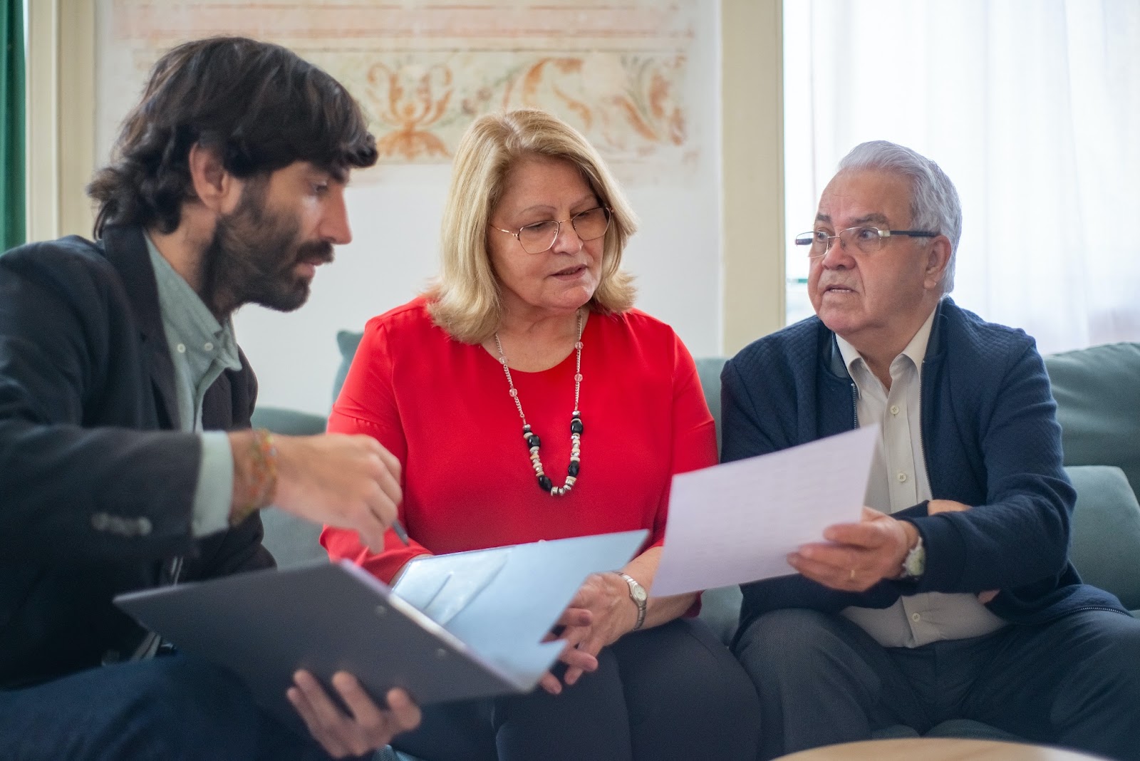 a lawyer explaining the insurance policy to an elderly couple
