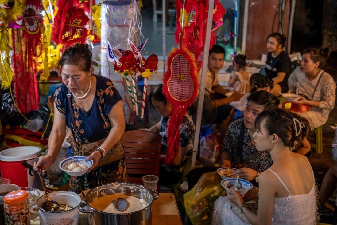 A street vendor prepares a dish in Hanoi, Vietnam. The nation’s economy is soaring, although the income gap is also widening. Photo: Getty Images
