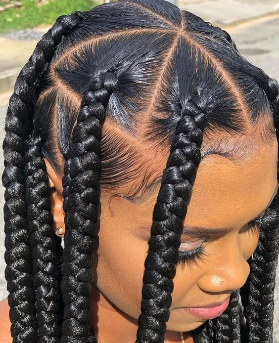picture of a lady with beautiful swooped down edges on her large knotless braids