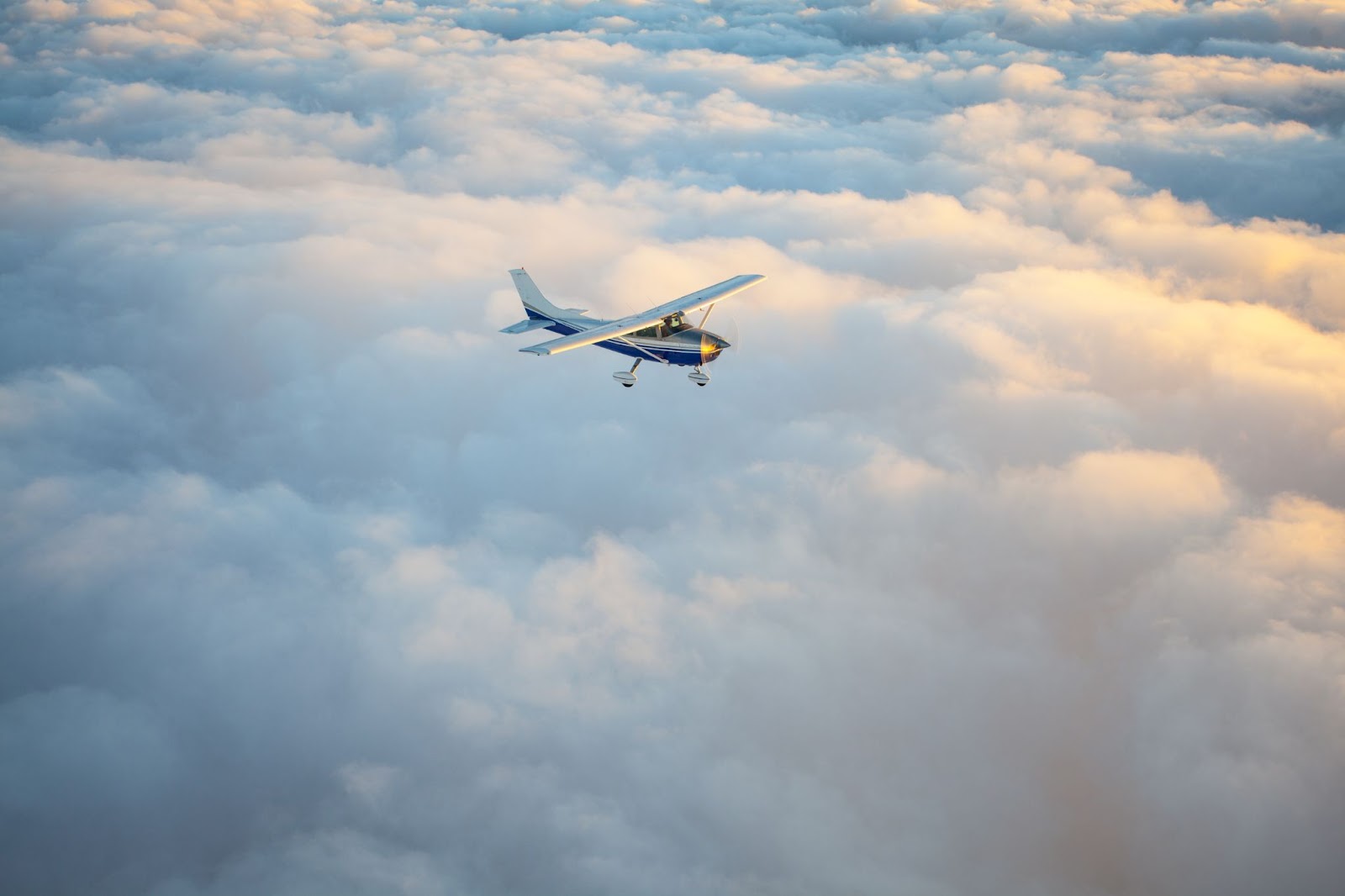 An airplane flying above the clouds.