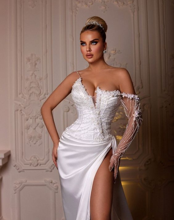 a lady wearing a corset wedding dress with high slit