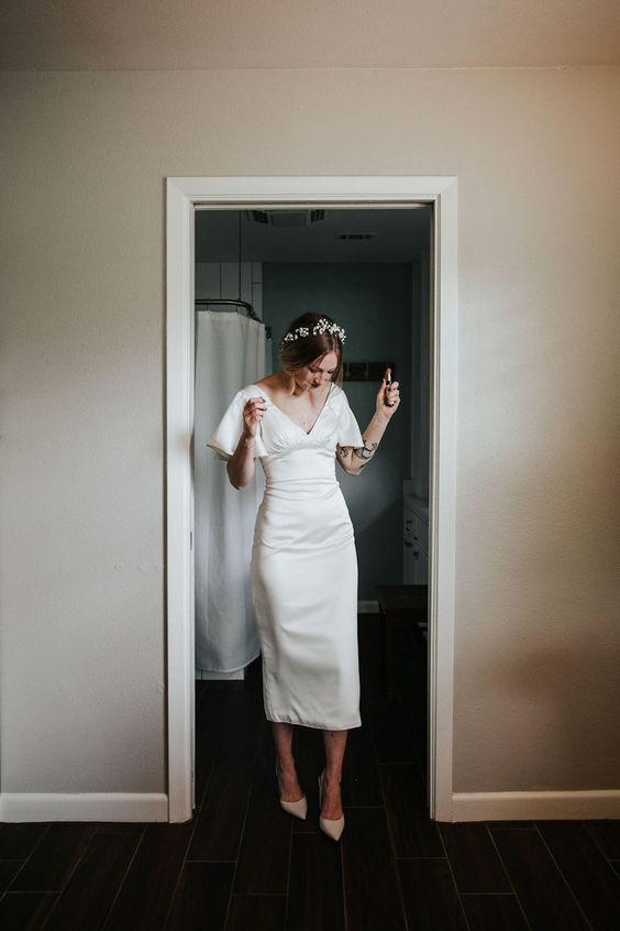 Woman in midi casual wedding dress with tiers
