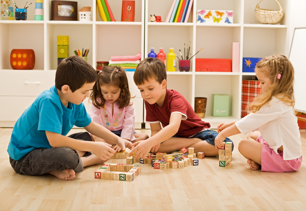 Children playing with blocks on the floor 