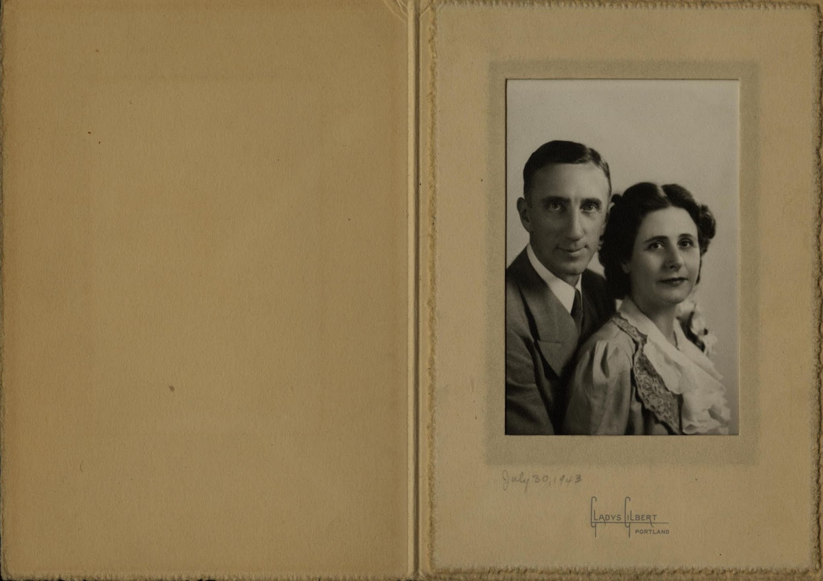 Wedding photograph of a man wearing a suit posed behind a woman, both looking into the camera. Dated July 30, 1943. Photograph by Gladys Gilbert, Portland.