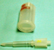 Components of a Unopette® Mycrocollection system: plastic reservoir with a known volume of solution and a capillary pipette stored inside a sharp ended-cover to perforate the plastic reservoir.
