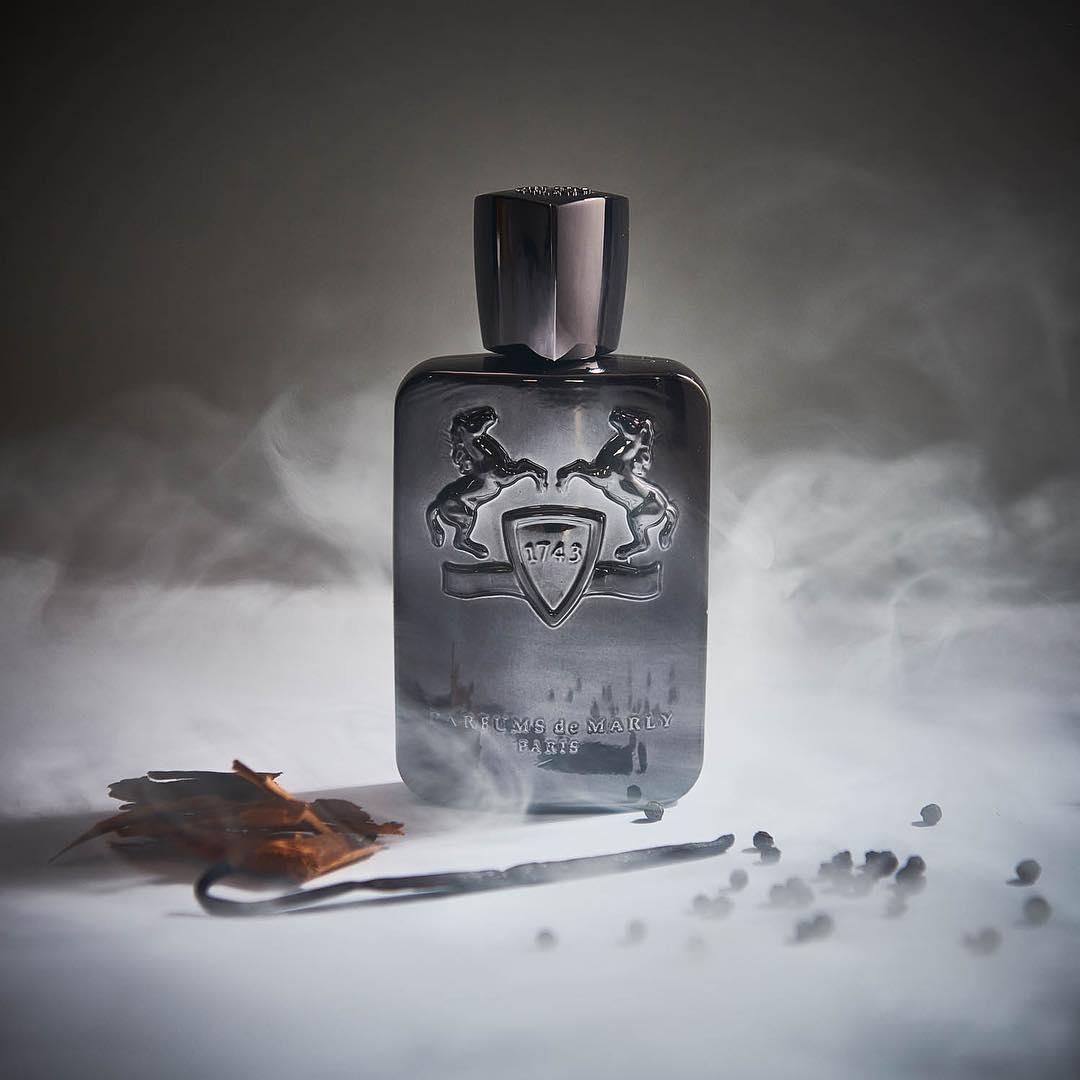 A bottle of perfume with smoke

Description automatically generated with low confidence
