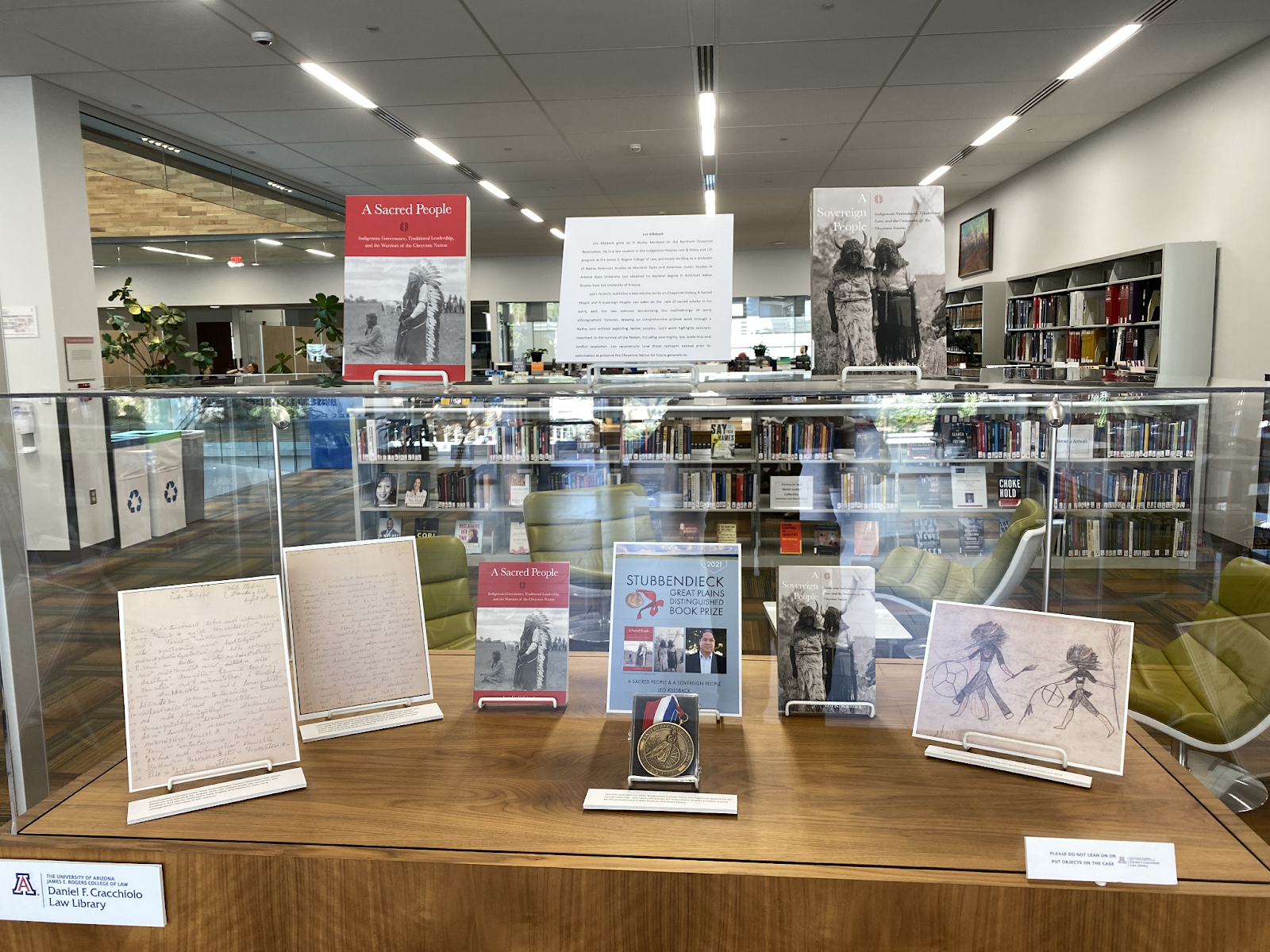 A photograph of Leo's exhibit featuring his award for the two volume series and photographs of archival interviews.