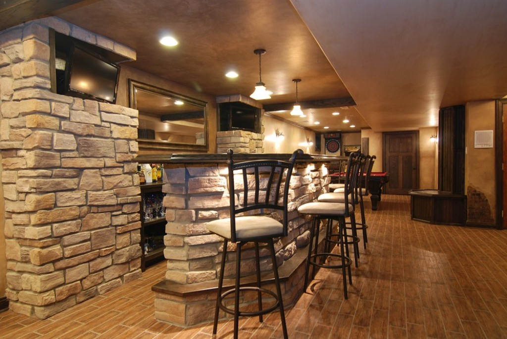 basement area with natural stone walls and stone bar