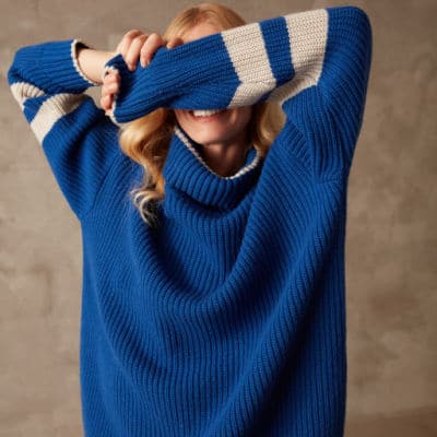 Person wearing a blue jumper from Mirla Beane, a British women's ethical clothing brand.
