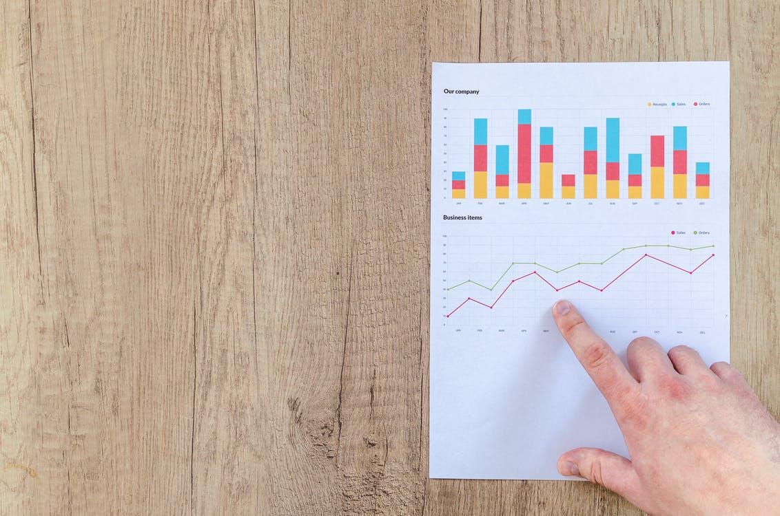 Free Person Pointing Paper Line Graph Stock Photo