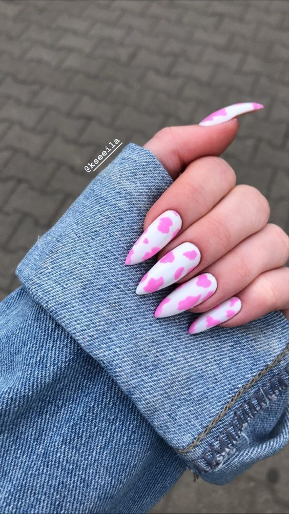 Lady shows off her pink cow print nails  in style 