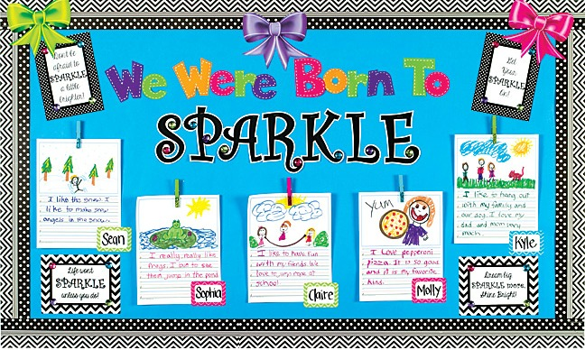 A bulletin board with completed All About Me worksheets displayed proudly by a teacher. The bulletin board has a header that reads "We were born to sparkle!"