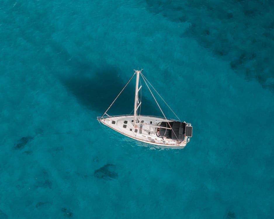 Free White Boat on Blue Sea Stock Photo