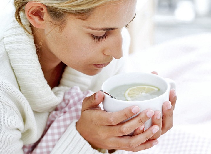 Woman holding a lemon water bowl