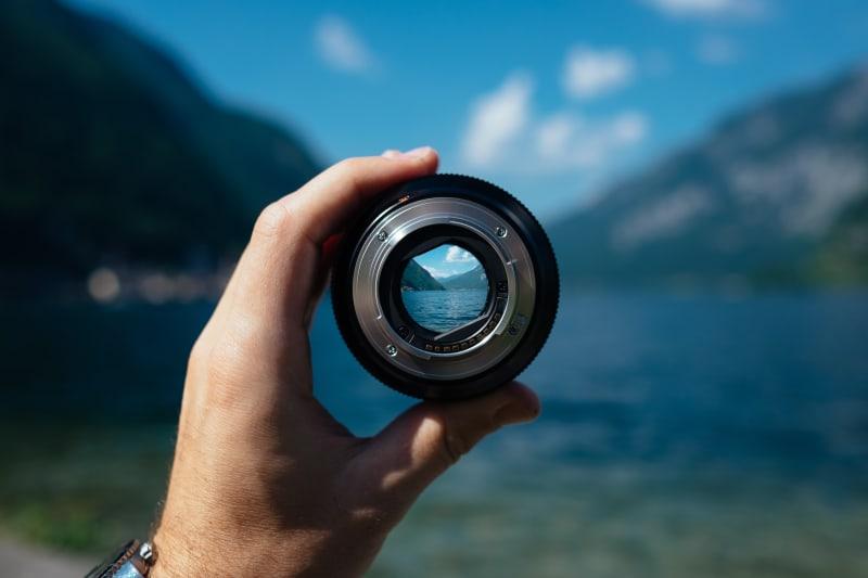 Camera lens showing a nature scene in focus