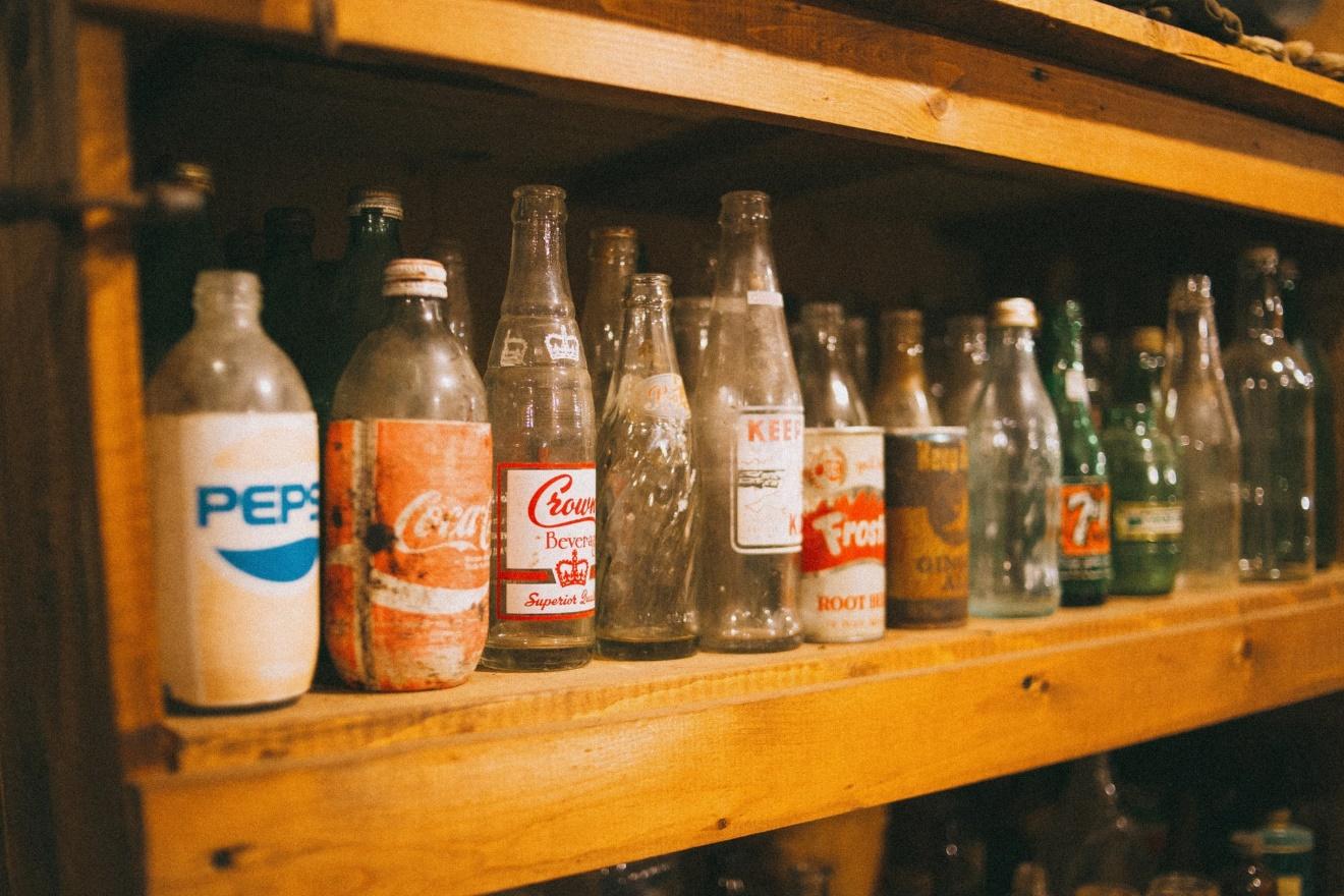 Professional Cleaning Service in Portland, Oregon Mess Maid Right NW organizes shelves with soda bottles. 