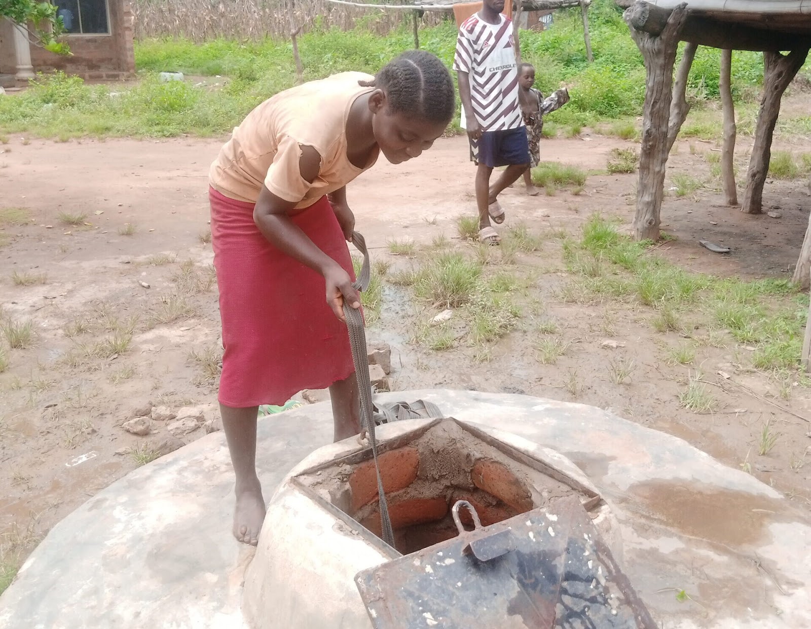 Torkwase Andrew getting water from the well