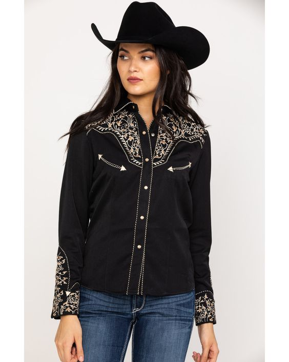 a cowgirl wearing a long-sleeved embroidered shirt