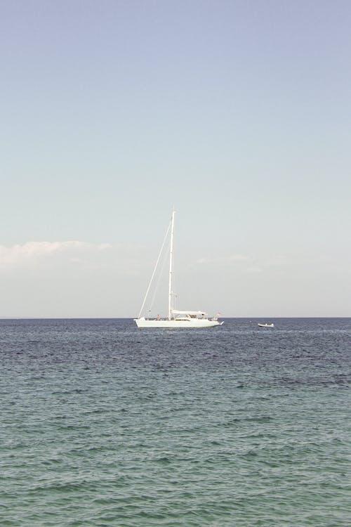 Free White Yacht on Sea Under Blue Sky Stock Photo