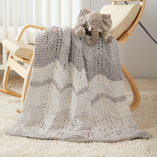 gray and white chevron knit baby blanket on rocking chair