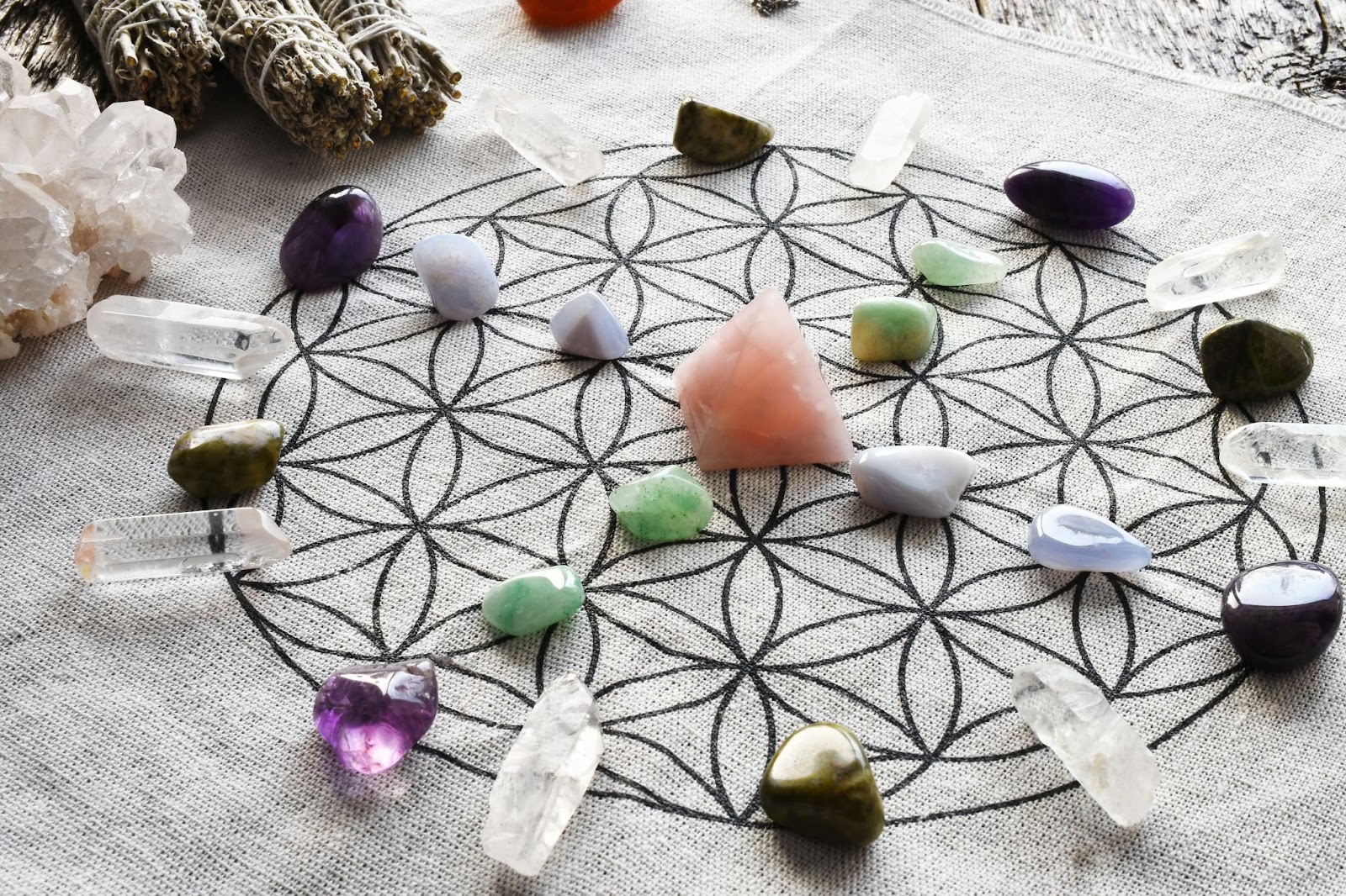 A crystal grid including a variety of crystals laid out in a circular format.