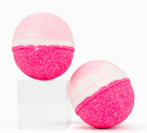 two bright pink and white bath bombs