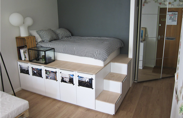 A platform bed made from IKEA kitchen cabinets. 