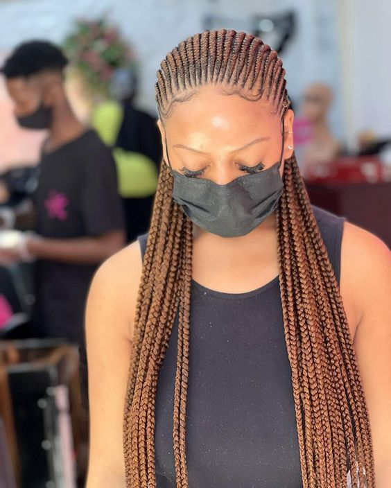 lady on facemask wearing Ghana braids