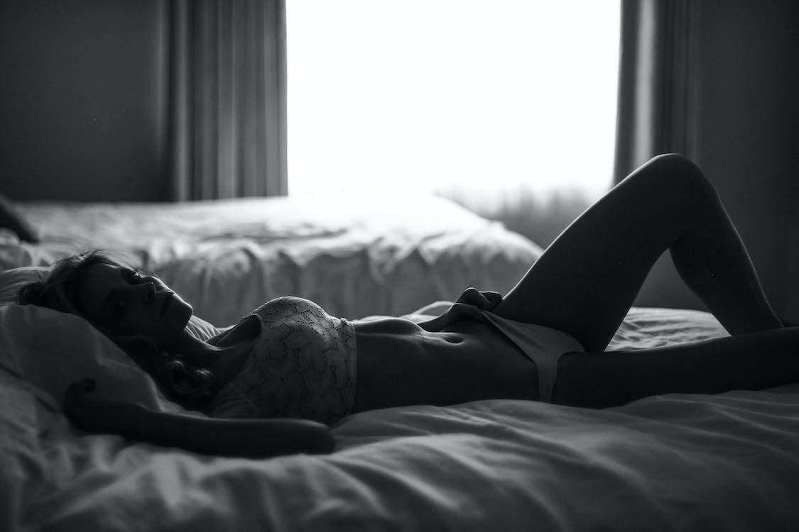 Free Woman Lying on Bed Stock Photo