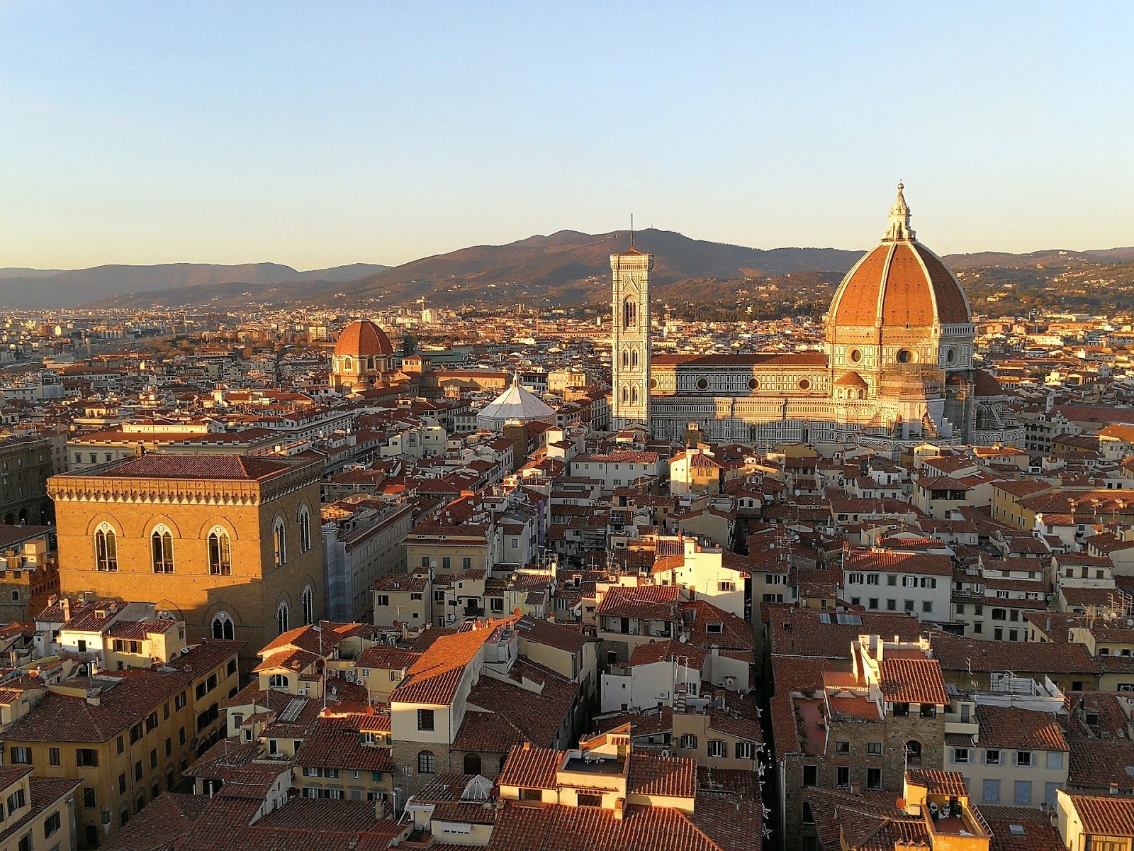 florence skyline city view from above during sunset colorful basilica and mountains in background. See Florence during our Italy road trip itinerary around Tuscany