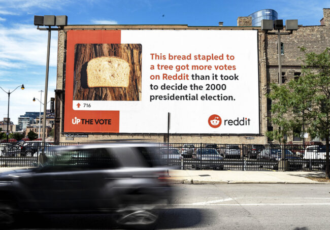 Reddit's Up the Vote campaign billboard, says "This bread stapled to a tree got more votes on Reddit than it took to decide the 2000 presidential election."