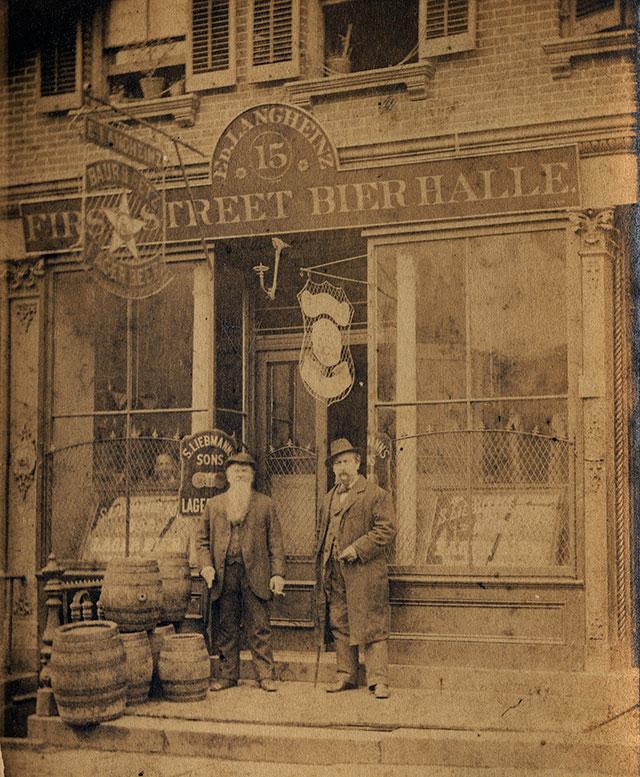 A couple of men standing in front of a building with a clock

Description automatically generated with medium confidence