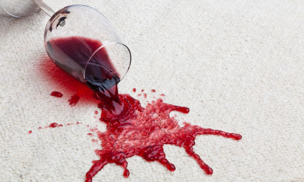 Red wine spilt on white carpet