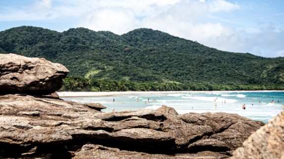 People swim in the water at a beach on Ilha Grande, Brazil.