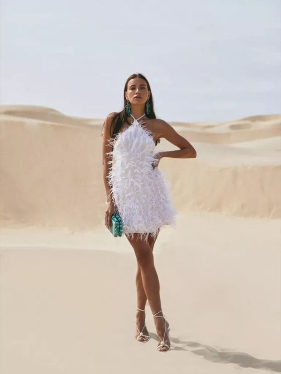 lady wearing fur little white dress in the desert